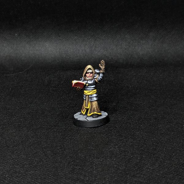 Painted Vestal miniature from Darkest Dungeon: The Board Game, hooded cleric raising a book