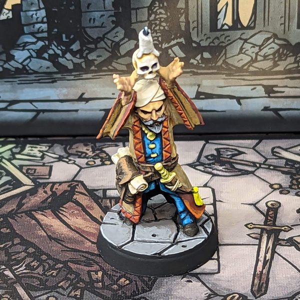 Painted Occultist miniature from Darkest Dungeon: The Board Game, summoning a floating skull
